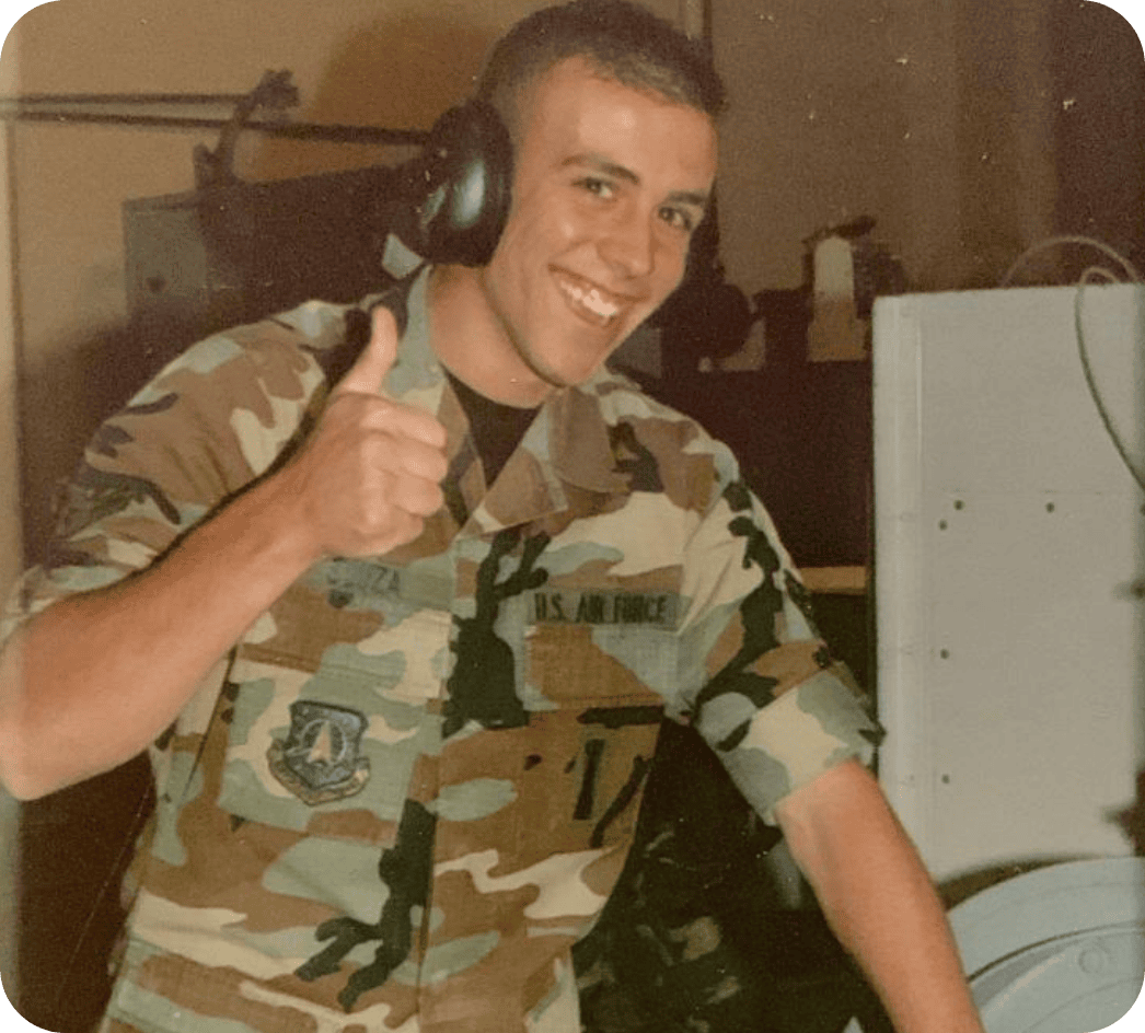 Owner Mike Souza smiling at camera during time in the United States Air Force.